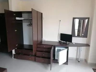 a desk with a computer and a mirror in a room at Студио in Lozenets