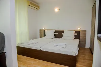 a bedroom with a bed with white sheets and white pillows at Clara Studio in Sarafovo by Flаt Manаger in Burgas City