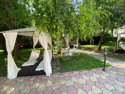a gazebo with a bike parked under a tree at ANITA B16 Studio Sunny Beach in Sunny Beach