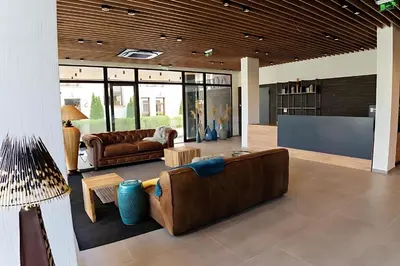 a living room with couches and a flat screen tv at Amara Sugar Hotel in Sunny Beach