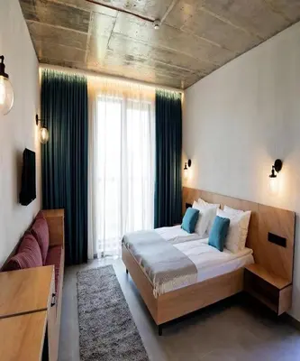 a bedroom with a large bed and a large window at Amara Sugar Hotel in Sunny Beach
