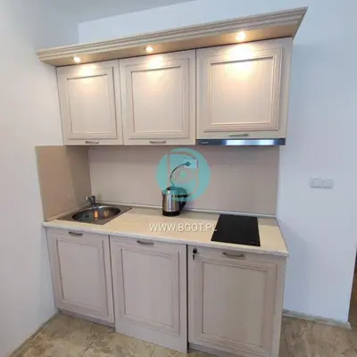a small kitchen with white cabinets and a sink at AVALON premium apartments in Sunny Beach