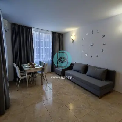 a living room with a couch and a table at AVALON premium apartments in Sunny Beach