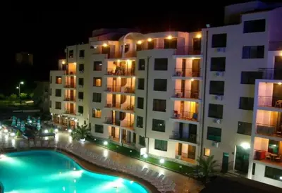 a large building with a swimming pool in front of it at AVALON premium apartments in Sunny Beach