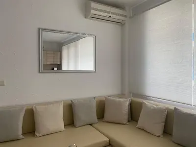 a living room with a couch with a mirror at VILLA ITTA 05 Apartment Sunny Beach in Sunny Beach