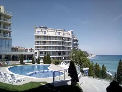 a large building with a swimming pool next to the ocean at Silver Beach B16 in Byala