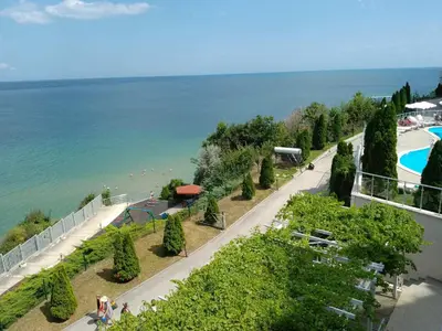 a road next to a swimming pool next to the ocean at Silver Beach B16 in Byala