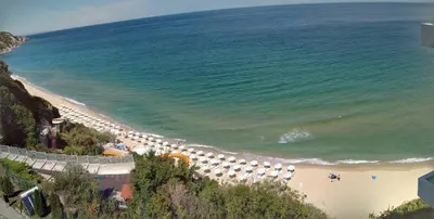 a beach with a bunch of umbrellas and the ocean at Silver Beach B16 in Byala