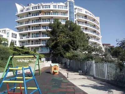 a large apartment building with a playground in front of it at Silver Beach B16 in Byala