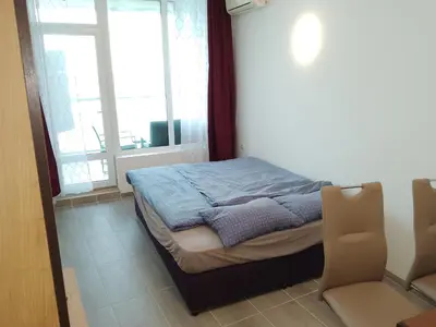 a small bed in a room with a window at Silver Beach B16 in Byala