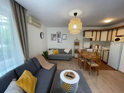 a living room with a blue couch and a table at Privilege Fort Beach - Prestige Sea Viev Apartments in Elenite