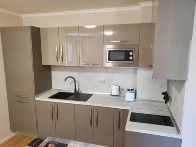 a kitchen with a sink and a microwave at Апартамент За Гости ,,1В-15