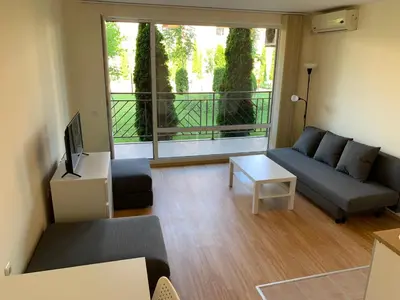 a living room with a couch and a tv at Holiday Fort Golf Club - Premium Apartments in Sunny Beach