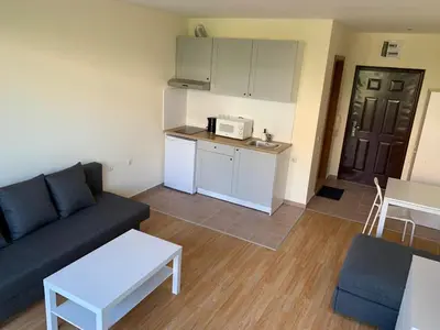 a small living room with a couch and a kitchen at Holiday Fort Golf Club - Premium Apartments in Sunny Beach