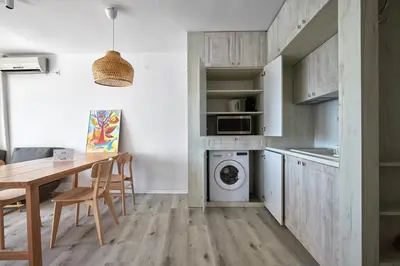 a kitchen with a table and a washing machine at 1BD Flat with a stunning SEA VIEW in Sozopol by Flаt Manаger in Sozopol