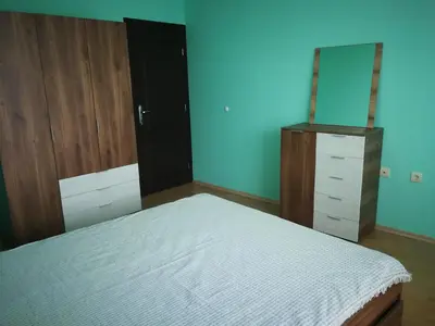 a bedroom with a bed and a dresser and a mirror at Апартамент за гости Соня Guest Apartment Sonya in Nesebar
