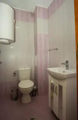 a bathroom with a toilet and a sink at Guest apartments STELA in Tsarevo