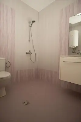 a bathroom with a shower and a toilet at Guest apartments STELA in Tsarevo