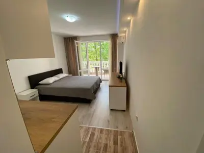 a small bedroom with a bed and a window at Студио Симона 3 - първа линия море in Lozenets