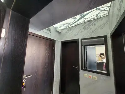 a bathroom with a mirror and some brown doors at Менада Хоризонт Апартаменти in Sozopol