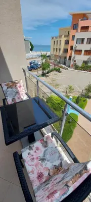 a balcony with a table and a laptop on it at Менада Хоризонт Апартаменти in Sozopol