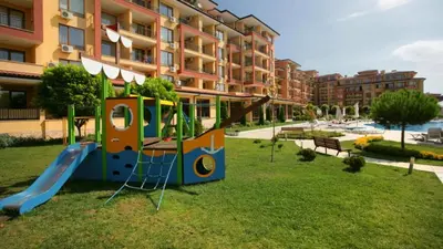 a playground in front of a building with a slide at Magic Dreams Apart Complex Studio Sveti Vlas in Sveti Vlas