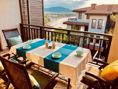 a table and chairs on a balcony with a view at Santa Marina 2-bedroom apt. w/ Sea View + Terrace in Sozopol