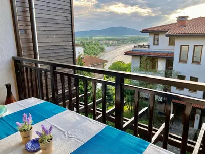 a balcony with a table and a view of a street at Santa Marina 2-bedroom apt. w/ Sea View + Terrace in Sozopol