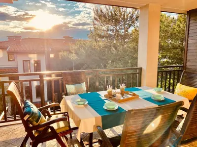 a table and chairs on a balcony with a view at Santa Marina 2-bedroom apt. w/ Sea View + Terrace in Sozopol