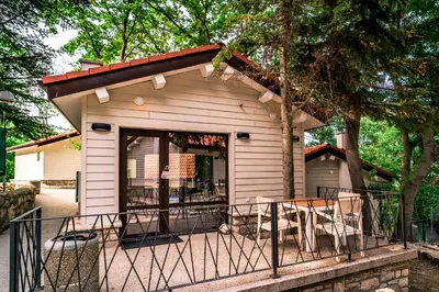a small white building with a porch at Къщички Синьо лято, Черноморец - Варна - Blue Summer Houses Varna in Varna City