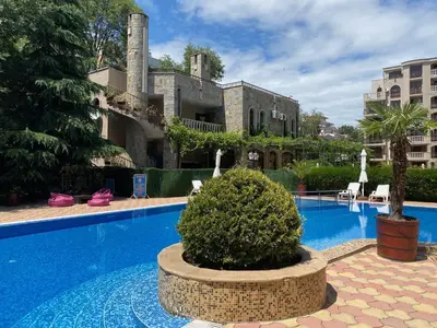 a resort with a swimming pool and a building at ANITA A15 Family Apartment Sunny Beach in Sunny Beach