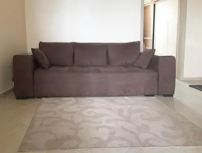 a brown couch in a living room with a rug at Kalia, Zweizimmer, Zweibalkon, Top-Apartment in Sunny Beach
