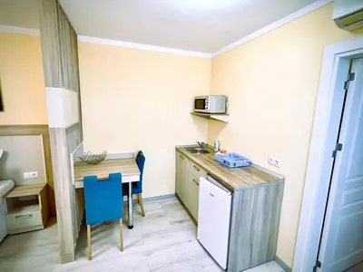 a small kitchen with a table and a microwave at Private apartments Stamopolu lux in Primorsko