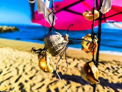 a beach with an umbrella on the sand at William's apartments - second cozy studio in Sveti Vlas