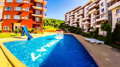 a swimming pool with a slide in front of a building at William's apartments - second cozy studio in Sveti Vlas