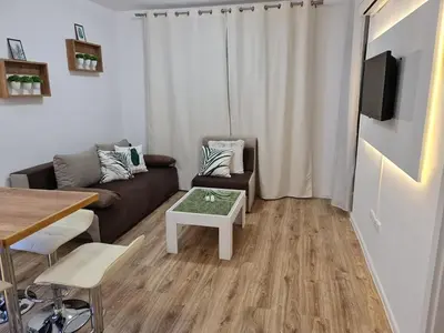 a living room with a couch and a table at Little Treasure by the Sea in Pomorie