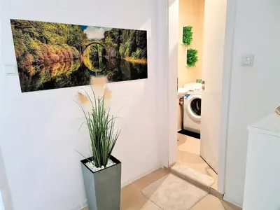 a bathroom with a painting on the wall at Little Treasure by the Sea in Pomorie