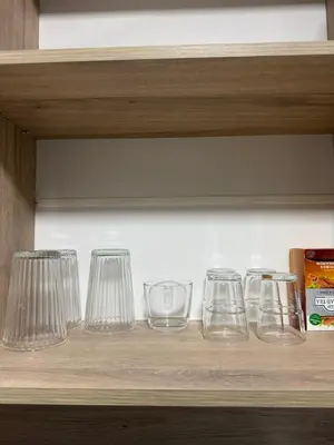 a row of glasses sitting on a shelf at Nõma studio in Varna City