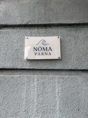 a sign on the side of a building at Nõma studio in Varna City