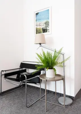 a chair and a table with a plant on it at Sea House Afrodita II in Nesebar