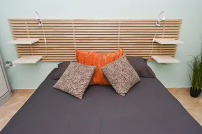a bed with two pillows on it in a room at Eli Apartment Burgas Center in Burgas City