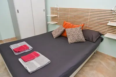 a black couch with pillows and towels on it at Eli Apartment Burgas Center in Burgas City