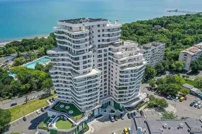 an aerial view of a tall white building with a pool at Luxury Apartments Alix in Burgas City