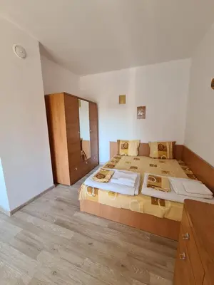a bedroom with a large bed and a wooden floor at Guest Rooms Kostovi in Nesebar