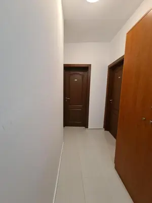 an empty hallway with two doors and a tile floor at Guest Rooms Kostovi in Nesebar
