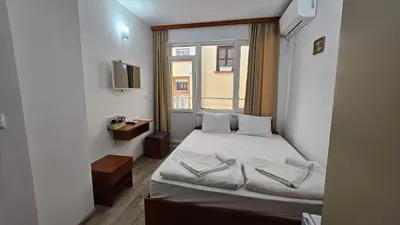 a small bedroom with a bed and a window at Guest Rooms Kostovi in Nesebar