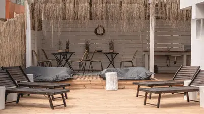 a patio with chairs and a table and a table and chairs at La Finca - Saint Vlas in Sveti Vlas