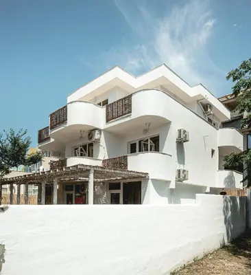 a white building with balconies on it at La Finca - Saint Vlas in Sveti Vlas