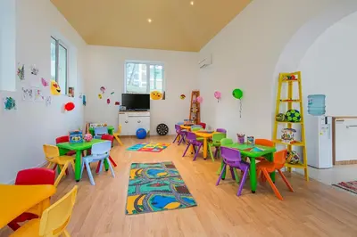 a classroom with tables and chairs and a tv at Hotel Forest Beach in Primorsko
