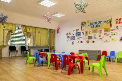 a classroom with colorful tables and chairs in a room at Hotel Forest Beach in Primorsko